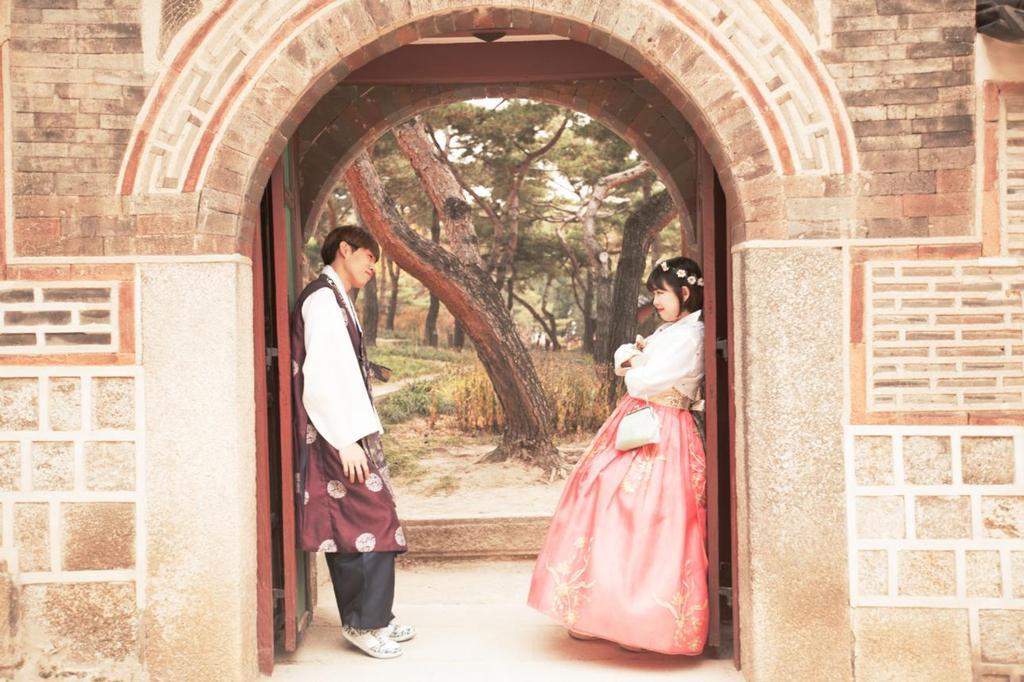 Couple wearing hanbok in traditional Korean architecture Seoul