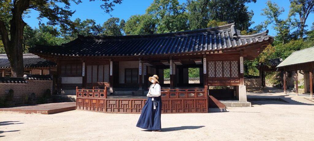 Traditional Korean hanok house with woman in cultural dress Seoul